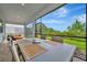 Covered patio featuring an outdoor dining area with scenic views of the surrounding landscape at 10394 Abaco Falls Dr, Englewood, FL 34223