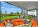 Relaxing screened porch featuring comfortable seating with a beautiful view of the manicured backyard at 10394 Abaco Falls Dr, Englewood, FL 34223
