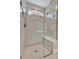 Shower with marble tile, window, and a built-in seat at 10394 Abaco Falls Dr, Englewood, FL 34223
