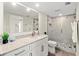 Bright bathroom with a large mirror, modern vanity, and tiled walk-in shower at 1055 Beach Rd # B302, Sarasota, FL 34242