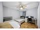 Inviting bedroom with two beds, a ceiling fan, and a dedicated workspace at 1122 42Nd E Ter, Bradenton, FL 34208