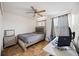 Cozy bedroom with ceiling fan, neutral walls, and a comfortable-looking bed and work space at 1122 42Nd E Ter, Bradenton, FL 34208