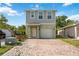 Two-story home featuring a charming front entrance, brick driveway, attached garage, and neutral paint colors at 1122 42Nd E Ter, Bradenton, FL 34208
