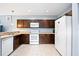Kitchen featuring essential appliances, ample cabinets, and neutral countertop, offering functionality and style at 1122 42Nd E Ter, Bradenton, FL 34208