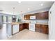 Open kitchen with ample cabinets, essential appliances, counter seating, and an open design to the living spaces at 1122 42Nd E Ter, Bradenton, FL 34208