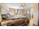 Main bedroom featuring a ceiling fan, neutral paint, and tile flooring, providing a relaxing and spacious retreat at 1122 42Nd E Ter, Bradenton, FL 34208