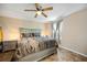 Large main bedroom offers comfort and style with a ceiling fan, tile floors, and a serene atmosphere for relaxation at 1122 42Nd E Ter, Bradenton, FL 34208