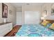 Bright bedroom featuring wood-look floors, a queen bed, and ample closet space at 12409 Osorio Ct # 102, Sarasota, FL 34238