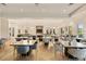 Spacious dining room with modern chandelier lighting and seating for large groups at 12409 Osorio Ct # 102, Sarasota, FL 34238