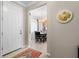 Welcoming foyer with a white door, decorative rug, and a glimpse into the dining area at 12409 Osorio Ct # 102, Sarasota, FL 34238