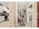 Bright hallway featuring tile floors, artwork, and access to the kitchen and laundry room at 12409 Osorio Ct # 102, Sarasota, FL 34238