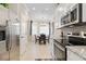 Bright kitchen next to breakfast nook featuring stainless steel appliances and granite countertops at 12409 Osorio Ct # 102, Sarasota, FL 34238