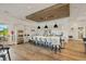Spacious kitchen featuring a long island with barstool seating, stainless steel appliances, and modern cabinets at 12409 Osorio Ct # 102, Sarasota, FL 34238