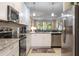 Kitchen boasts stainless steel appliances, granite countertops, and white cabinets with views to great room at 12409 Osorio Ct # 102, Sarasota, FL 34238