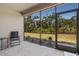 Enclosed lanai with screen windows offers a view of the green landscape at 12409 Osorio Ct # 102, Sarasota, FL 34238