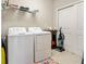 Functional laundry room equipped with a washer, dryer, storage shelves, and a closet at 12409 Osorio Ct # 102, Sarasota, FL 34238