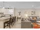 Open-concept living space with a bar, connecting the kitchen and living area with comfortable seating at 12409 Osorio Ct # 102, Sarasota, FL 34238