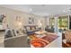 Cozy living room featuring neutral tones, comfortable seating, and a colorful patterned rug at 12409 Osorio Ct # 102, Sarasota, FL 34238