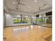 Spacious yoga studio with hardwood floors, large windows with a view, and a full wall of mirrors for group fitness at 12409 Osorio Ct # 102, Sarasota, FL 34238
