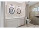 Bathroom features a double sink vanity, a walk-in shower with glass door, and neutral color scheme at 1308 Willow Oak Cir, Bradenton, FL 34209