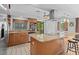 Bright kitchen features stainless appliances, granite countertops, and an island with seating at 1308 Willow Oak Cir, Bradenton, FL 34209