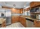 Well-lit kitchen with stainless steel appliances, granite countertops, and ample cabinet space at 1308 Willow Oak Cir, Bradenton, FL 34209