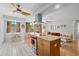 Bright kitchen with a granite island, stainless steel appliances, and easy access to the living area at 1308 Willow Oak Cir, Bradenton, FL 34209