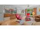 Bright living room with a view into the kitchen, hardwood floors and glass doors to the outside at 1308 Willow Oak Cir, Bradenton, FL 34209