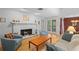 Cozy living room with a white-painted brick fireplace, light hardwood floors, and comfortable seating at 1308 Willow Oak Cir, Bradenton, FL 34209