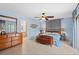 Main bedroom with light blue walls, tile floors, and sliding glass doors to the outside at 1308 Willow Oak Cir, Bradenton, FL 34209