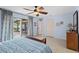 Main bedroom with tile floors, ceiling fan, and a sliding glass door leading to the patio at 1308 Willow Oak Cir, Bradenton, FL 34209
