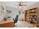 Cozy office with a large desk, bookcase, and natural light from the window at 1308 Willow Oak Cir, Bradenton, FL 34209