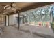 Large screened patio with a ceiling fan and plenty of space for outdoor seating at 1308 Willow Oak Cir, Bradenton, FL 34209