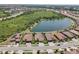 Expansive aerial shot capturing homes by a serene lake, showcasing community living and neighborhood layout at 13587 Vancanza Dr, Venice, FL 34293