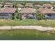 Aerial view of homes with screened-in pools, backing onto a lake, creating a private and peaceful backyard oasis at 13587 Vancanza Dr, Venice, FL 34293
