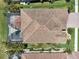 Aerial view of home features a tile roof, screened-in pool, and lush landscaping, blending luxury and outdoor living at 13587 Vancanza Dr, Venice, FL 34293