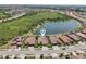 Expansive aerial shot capturing homes by a serene lake, showcasing community living and neighborhood layout at 13587 Vancanza Dr, Venice, FL 34293
