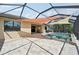 Screened-in pool and patio boasts sunshades and seamless access to the indoor living space with lovely pavers at 13587 Vancanza Dr, Venice, FL 34293
