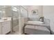 Lovely bathroom featuring a glass enclosed shower and soaking tub with storage bench at 13587 Vancanza Dr, Venice, FL 34293