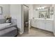 The bathroom boasts tiled floors, a soaking tub, and a bright vanity at 13587 Vancanza Dr, Venice, FL 34293
