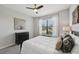 Comfortable bedroom with large window, ceiling fan, and floral painting above the dresser at 13587 Vancanza Dr, Venice, FL 34293