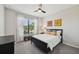 Bright bedroom with a ceiling fan, large window, and modern furnishings at 13587 Vancanza Dr, Venice, FL 34293