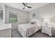 Cozy bedroom featuring a white bed frame, soft gray carpet, and a well-lit space at 13587 Vancanza Dr, Venice, FL 34293