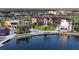Beautiful aerial view of a lakeside community with modern buildings, green spaces, and walking paths at 13587 Vancanza Dr, Venice, FL 34293