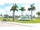 Exterior view of CoolToday Park, a baseball stadium surrounded by palm trees and green spaces at 13587 Vancanza Dr, Venice, FL 34293