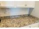 Close-up on the countertop with a white tiled backsplash at 13587 Vancanza Dr, Venice, FL 34293