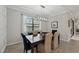 Dining room featuring a view of the lake, elegant lighting fixture and plenty of natural lighting at 13587 Vancanza Dr, Venice, FL 34293