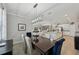 Open-concept dining room with elegant lighting fixture and stylish, comfortable chairs at 13587 Vancanza Dr, Venice, FL 34293