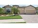 Charming single-Gathering home with a two-car garage, well-maintained landscaping, and brick driveway at 13587 Vancanza Dr, Venice, FL 34293