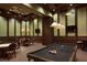 Inviting game room with a pool table, seating, and sophisticated lighting at 13587 Vancanza Dr, Venice, FL 34293